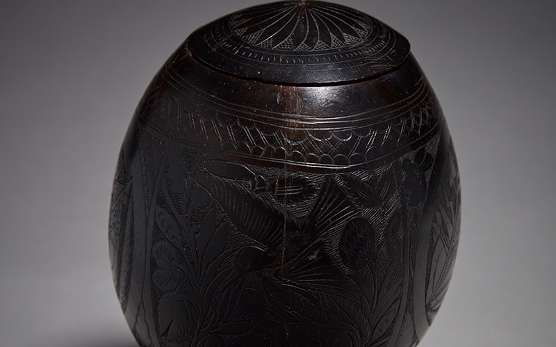Early Scrimshaw Coconut with fine elaborate carving to surface, 19th Century